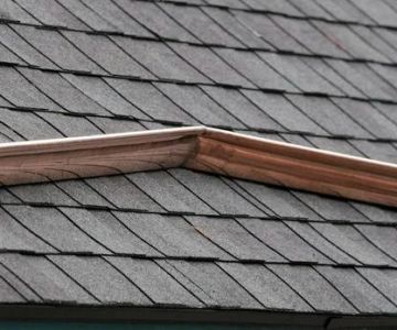 How to Install a Roof Saddle to Divert Water on a Flat Roof