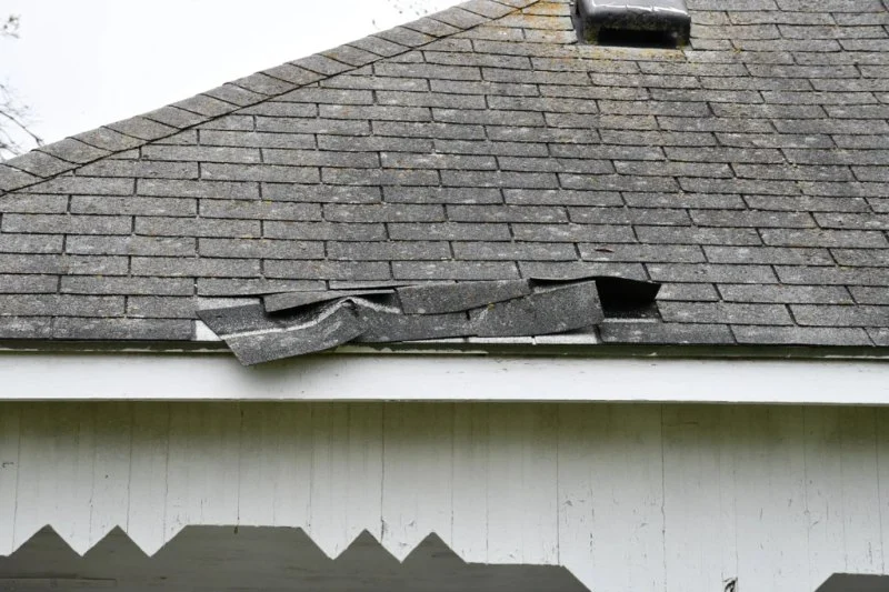 Wind Damage to Roofs: How to Identify Lifted Shingles and Damaged Flashing