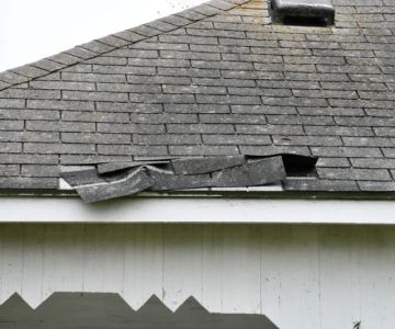 Wind Damage to Roofs: How to Identify Lifted Shingles and Damaged Flashing